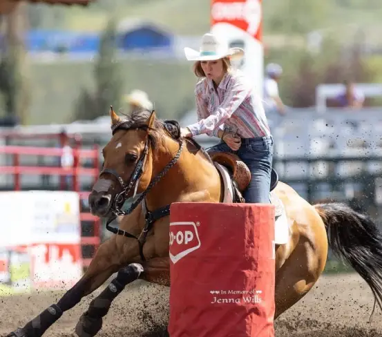 Woman riding a horse in the rodeo finals